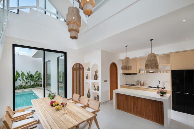 Modern kitchen and dining area with pool view.