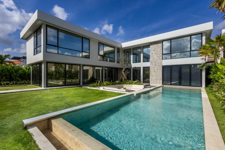 Modern house with glass windows and swimming pool.