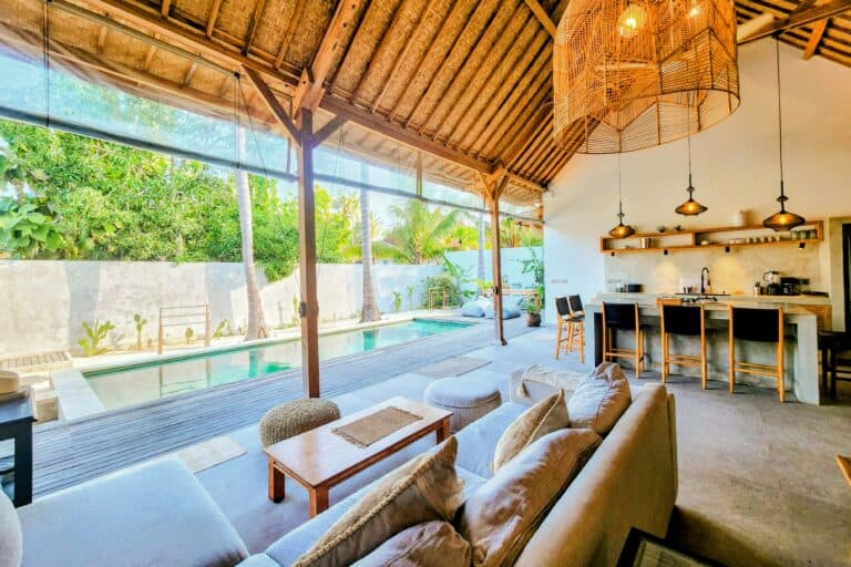 Modern tropical living room with pool and kitchen.