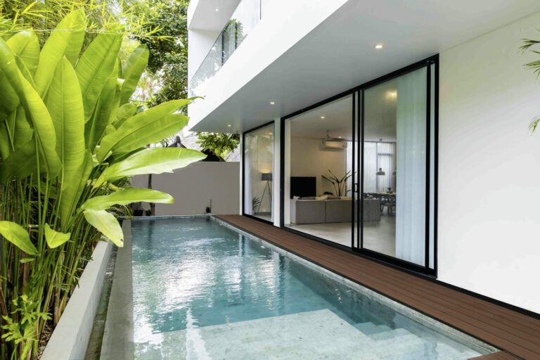 Modern house with pool and garden view.