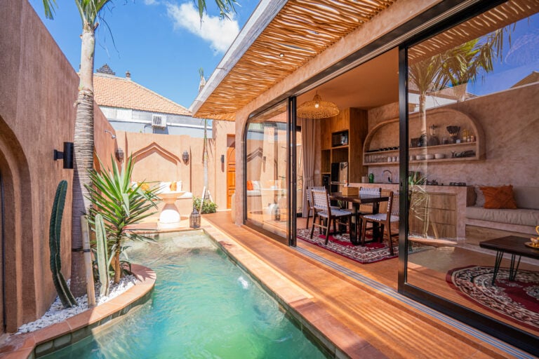 Modern patio with pool, plants, and outdoor seating