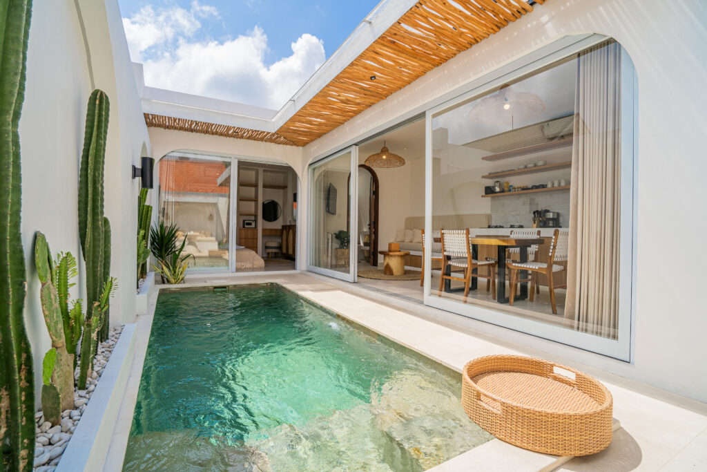 Modern house with outdoor pool and glass doors.