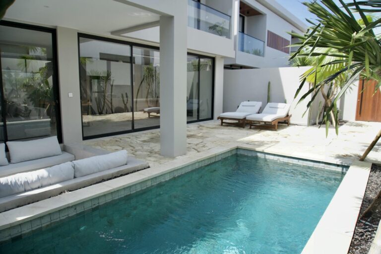Modern backyard with pool and lounge chairs