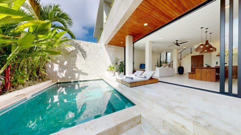 Modern tropical villa with pool and open living area.