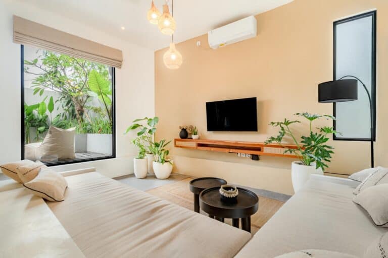 Modern living room with plants and beige decor.