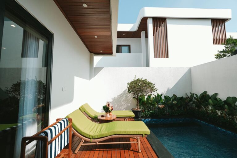 Modern patio with lounge chairs by a pool
