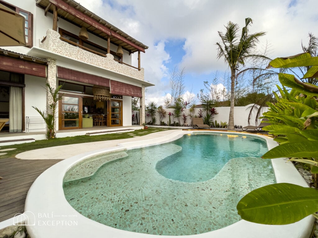 Luxury villa with outdoor pool and tropical garden.