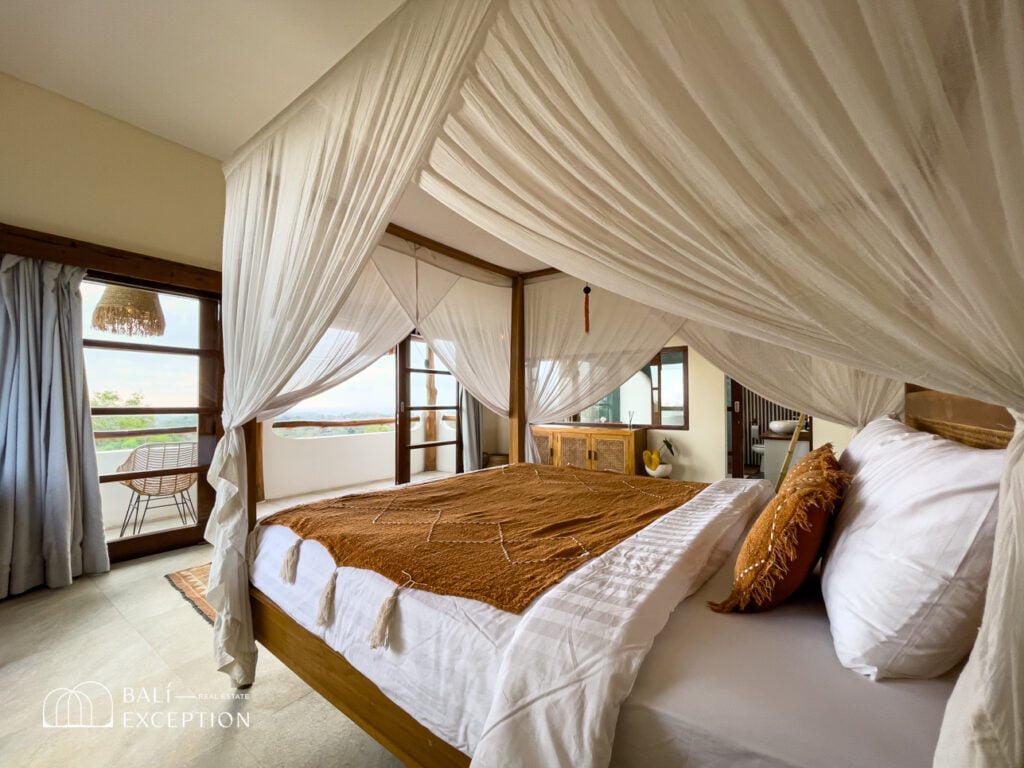 Luxurious bedroom with canopy bed and outdoor view