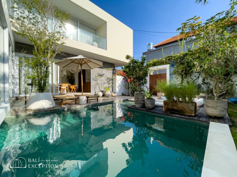 Modern villa with pool and outdoor seating.