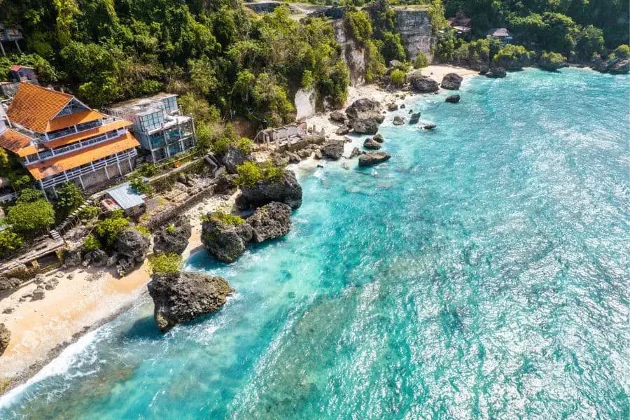 Aerial view of coastal beach and buildings.