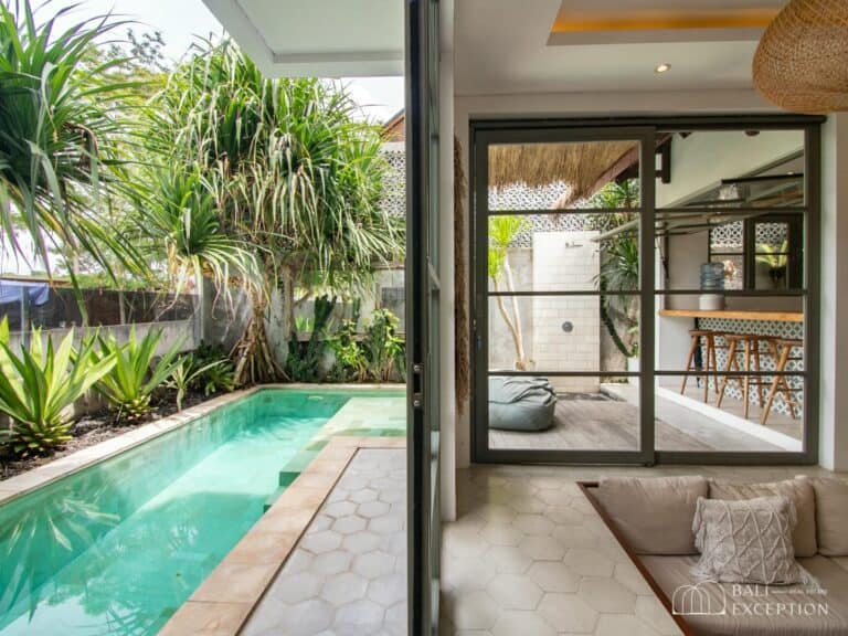 Modern living area with a view of pool.