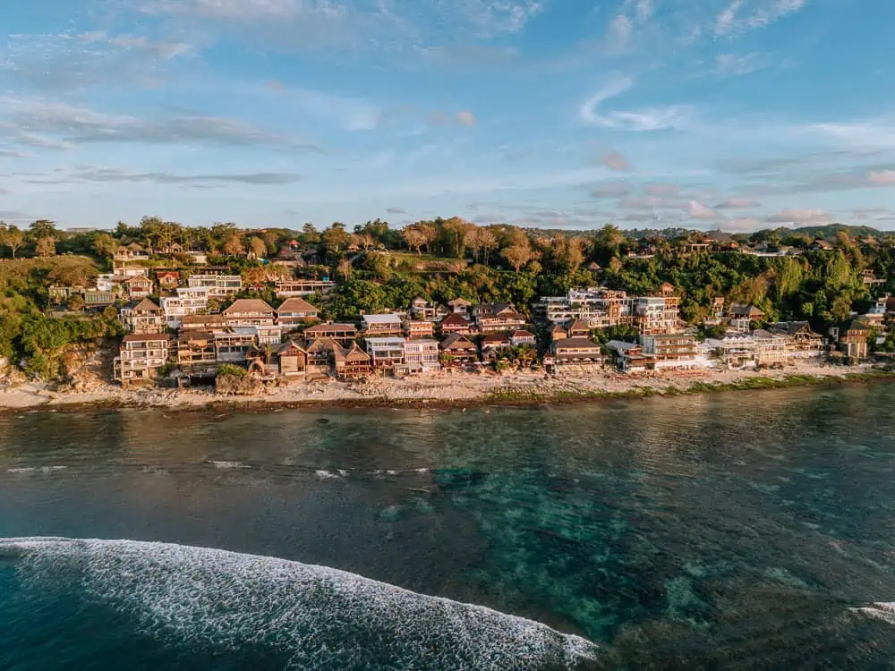 Coastal village with houses along the shoreline.