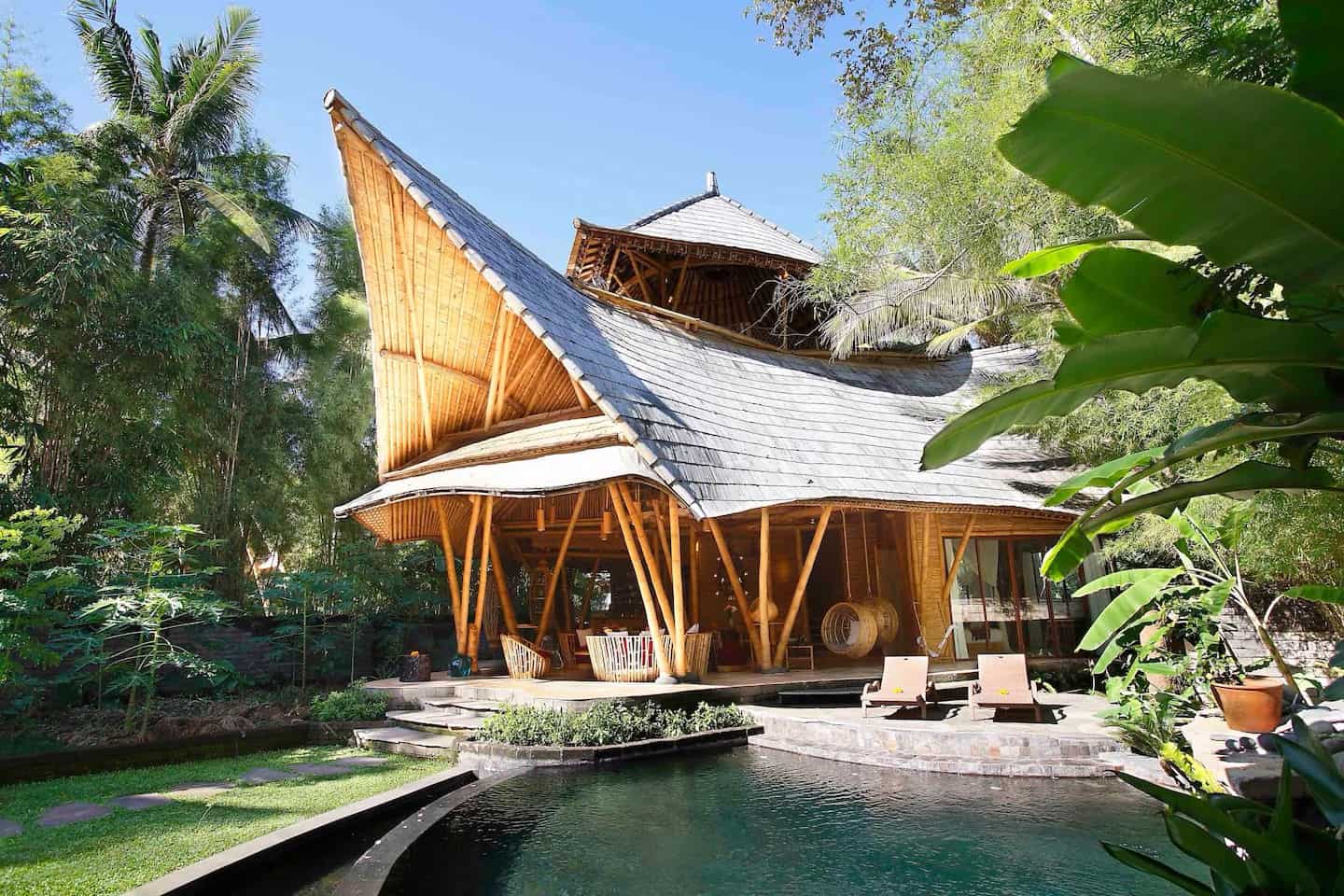 Tropical bamboo house with pool in lush garden