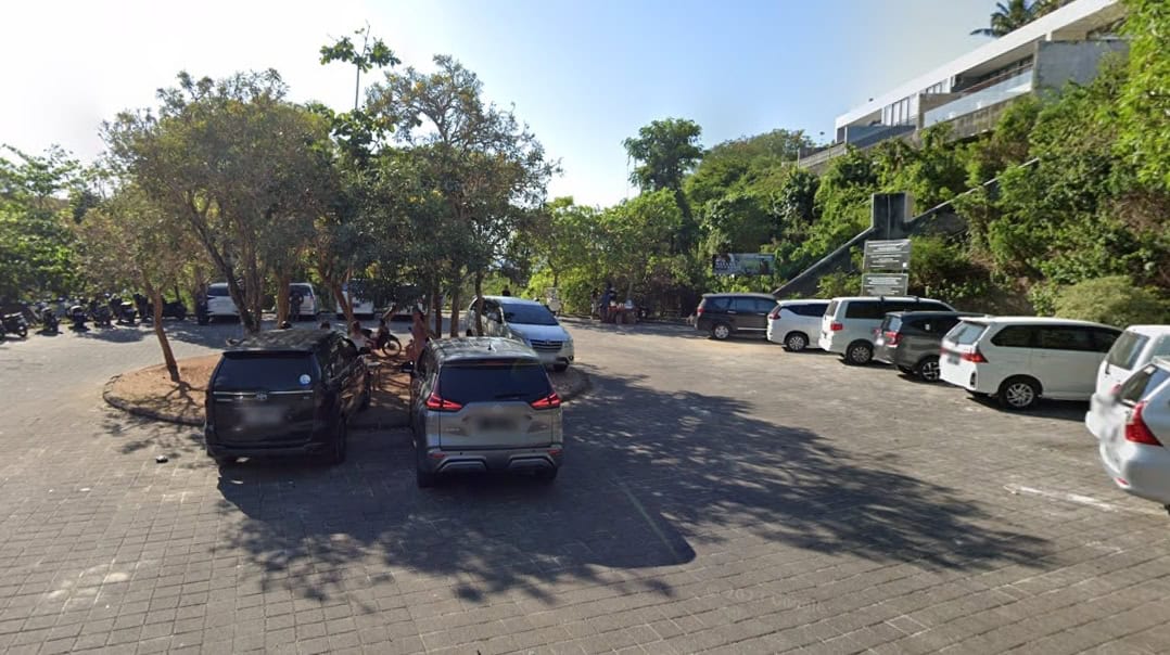 Parking lot with trees and parked cars