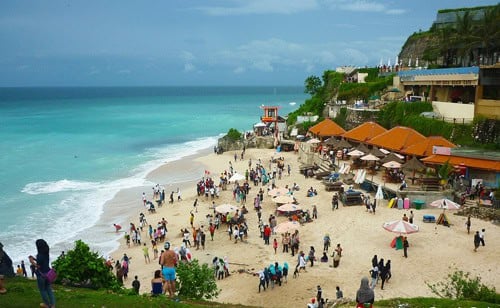 Crowded beach with ocean waves