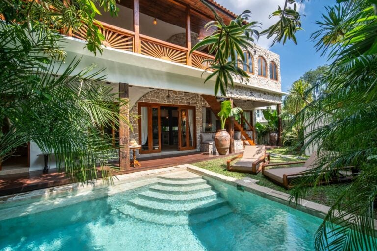 Tropical villa with pool and lush garden.