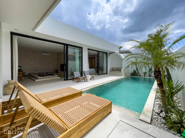 Modern villa with private pool and lounge chairs.