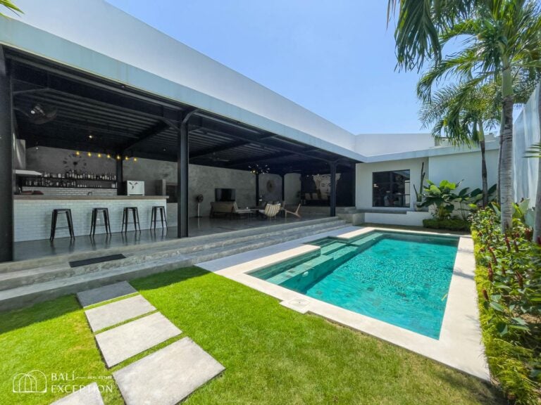 Modern villa with pool and outdoor bar area.