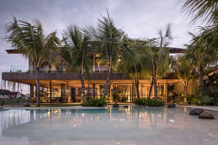 Modern house with tropical landscaping and pool.