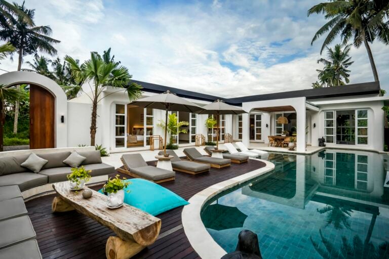 Luxurious villa with pool and lounging area.