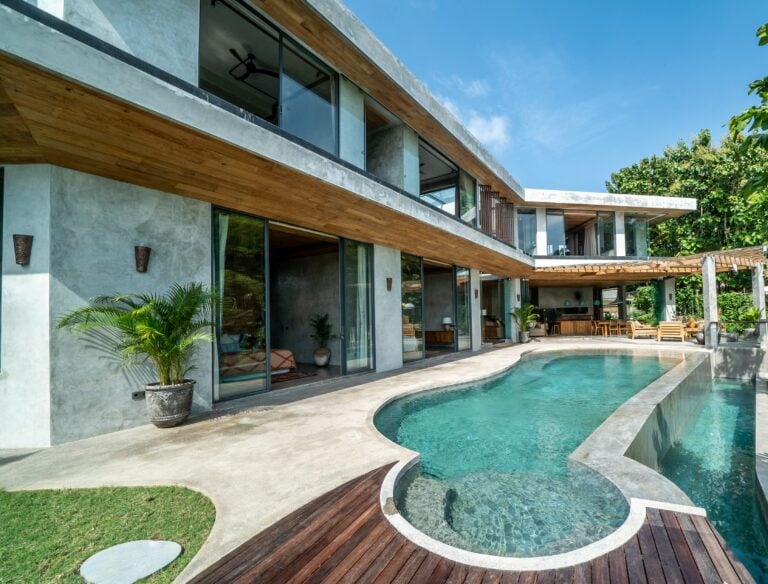 Modern house with outdoor pool and patio area.