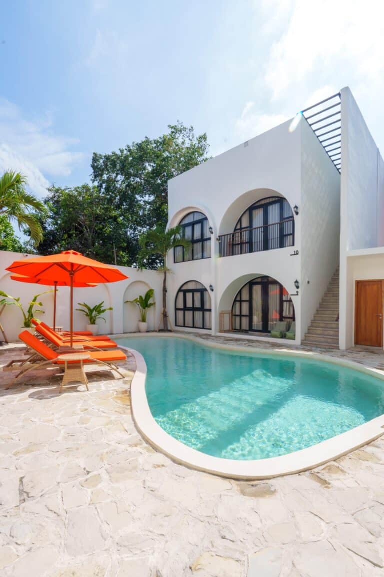 Modern villa with pool and red loungers