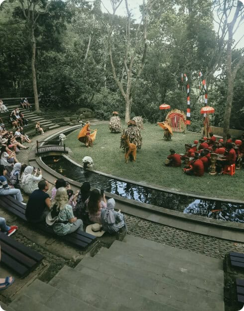 Outdoor cultural dance performance with audience watching.