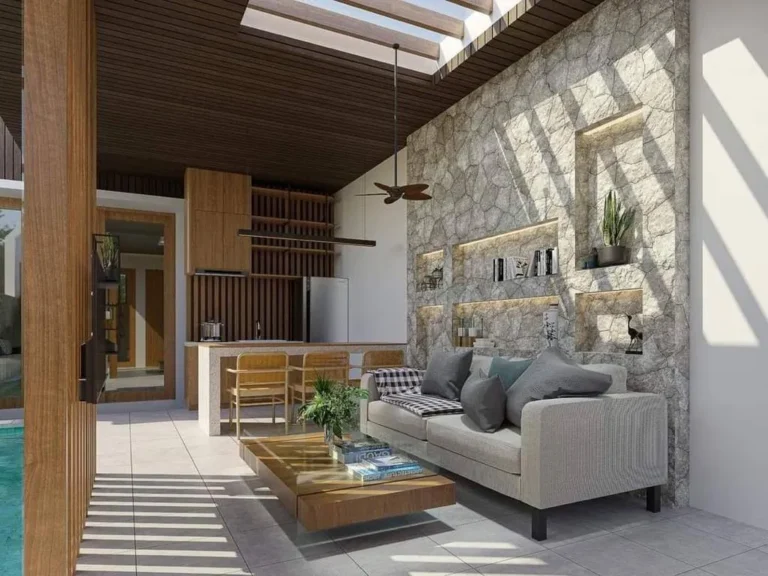 Modern living room with stone wall and natural light.