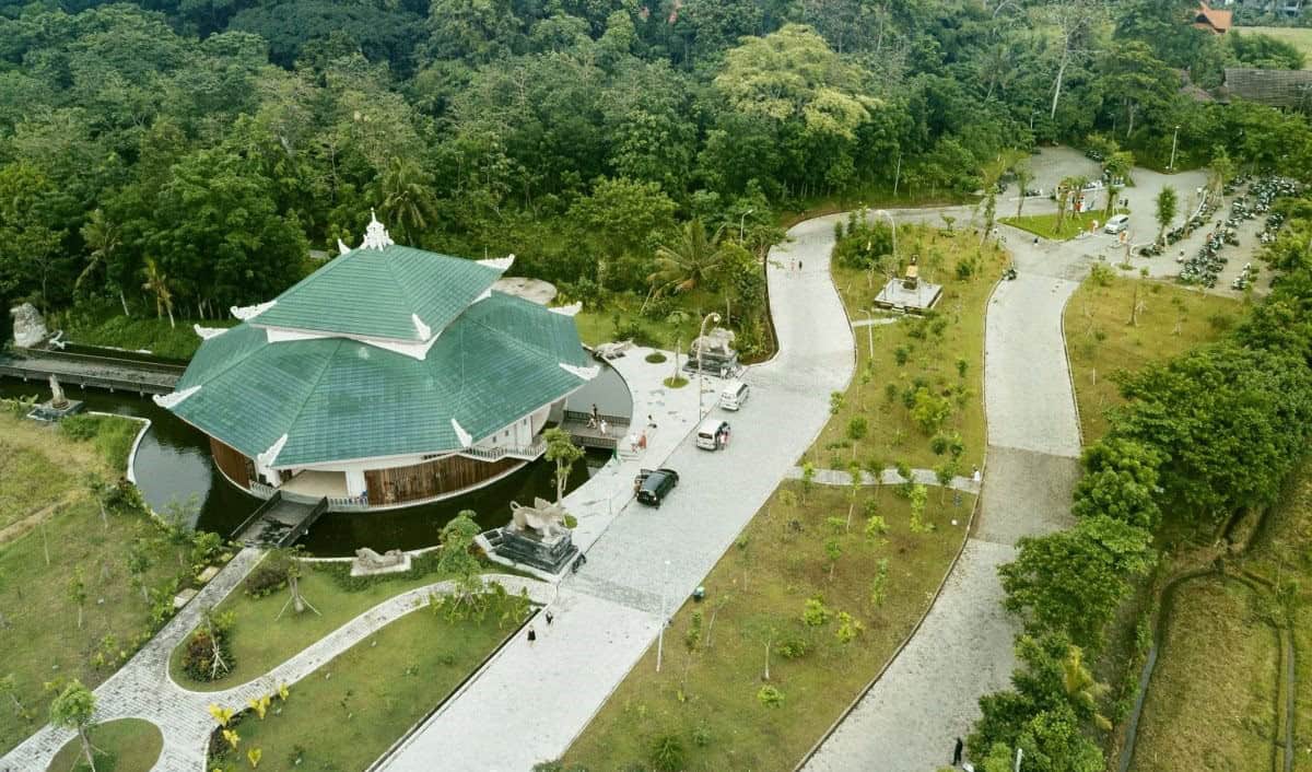 Aerial view of building surrounded by greenery.