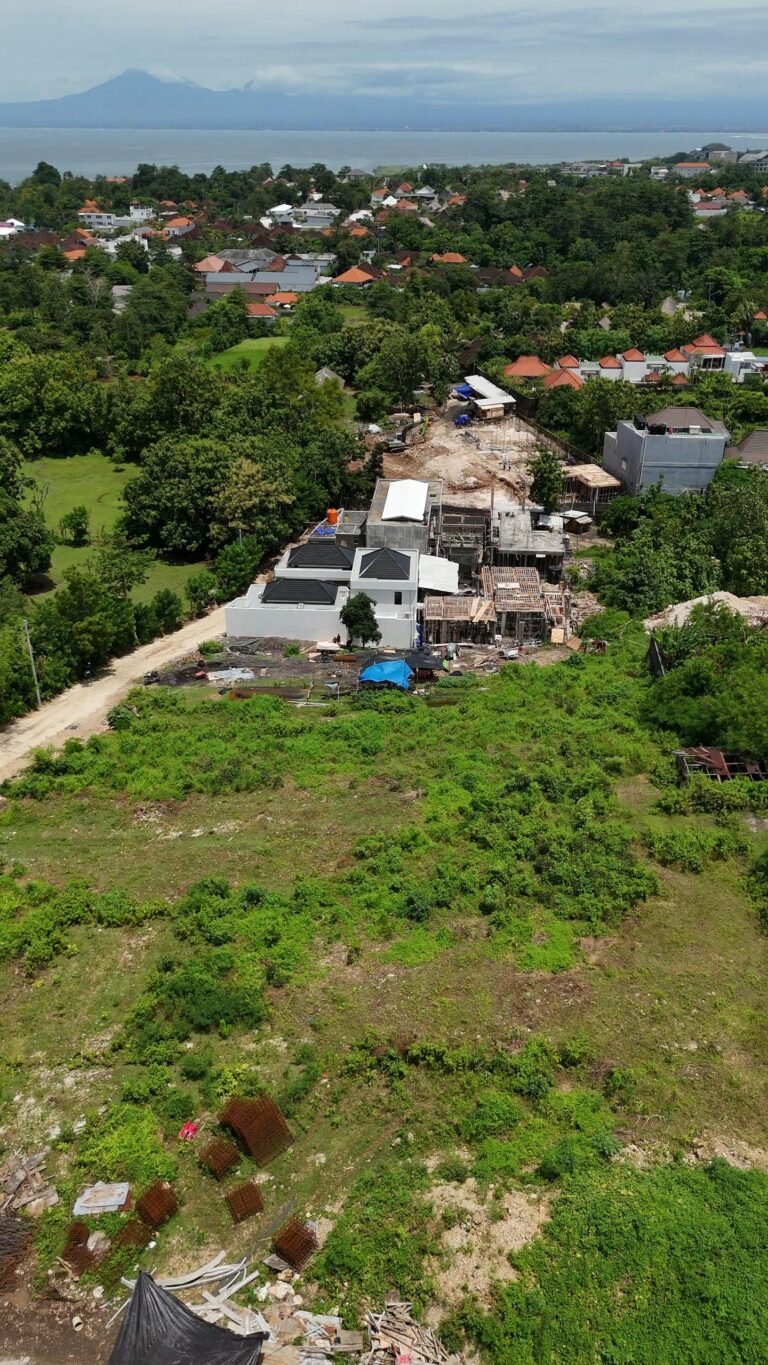 Aerial view of landscape with construction and greenery.