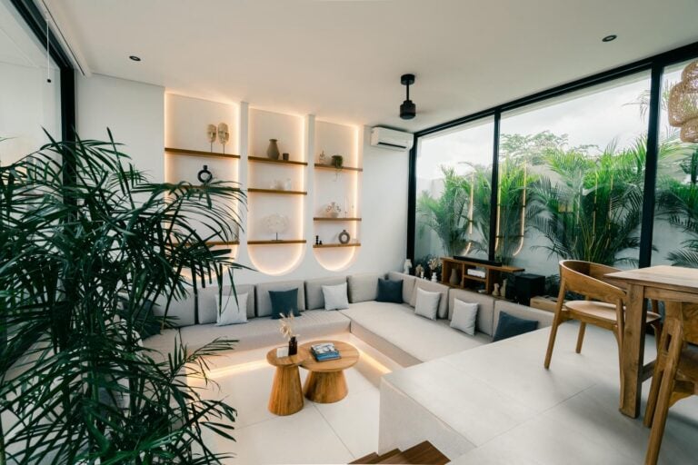 Modern living room with greenery and wooden furniture.