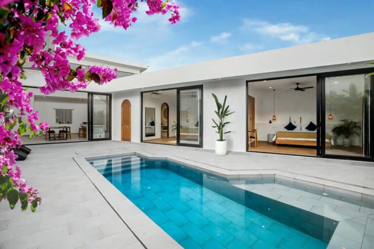 Modern home with pool and pink flowers