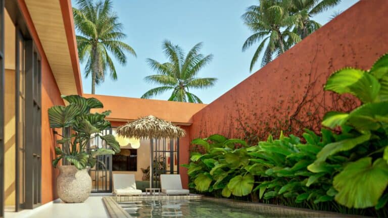 Tropical courtyard with pool, palm trees, and loungers.