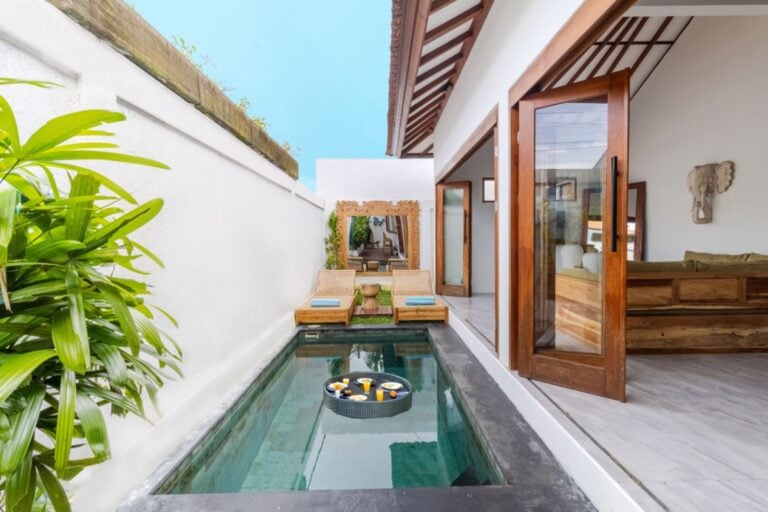 Tropical villa with private pool and loungers.