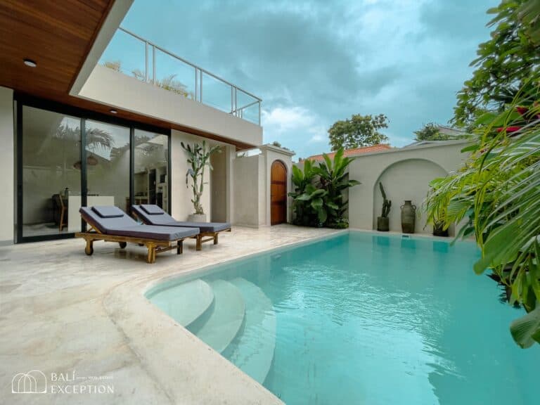 Modern villa with pool and lounge chairs.