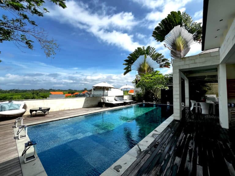 Luxury villa with pool and lush garden view.