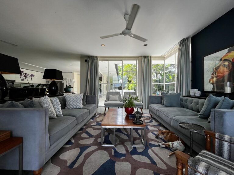 Modern living room with large sofas and decorations.