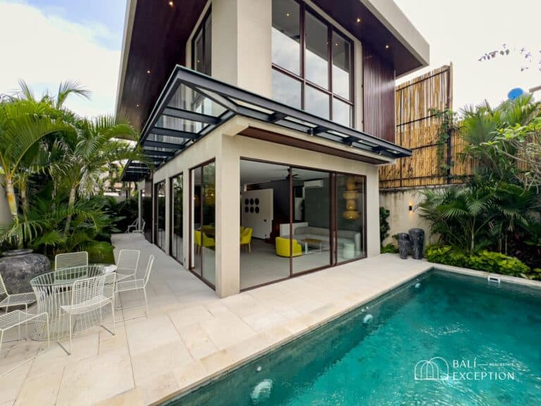 Modern villa with pool in tropical setting.