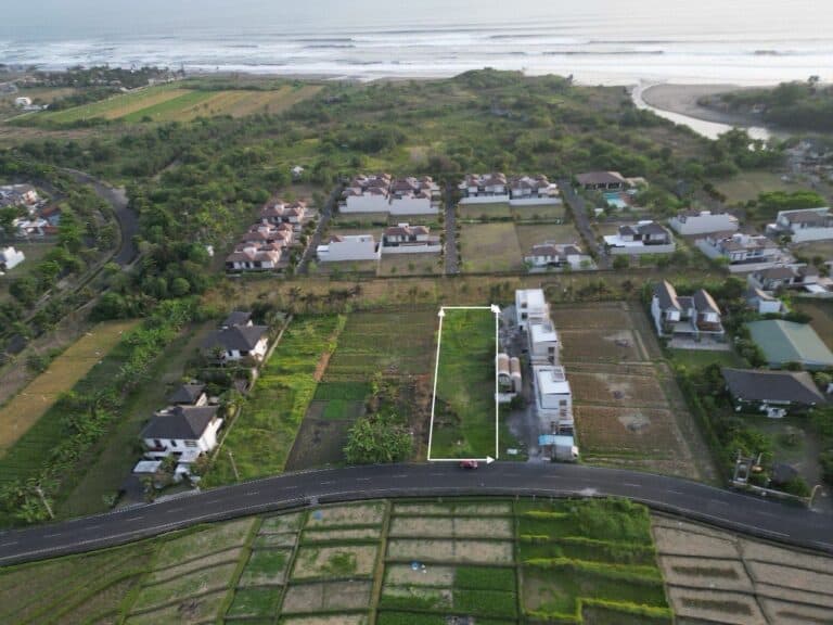 Aerial view of coastal farmlands and residential area.