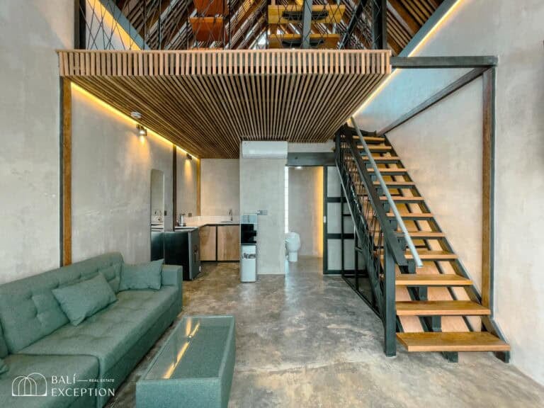 Modern loft apartment with wood accents and stairs.