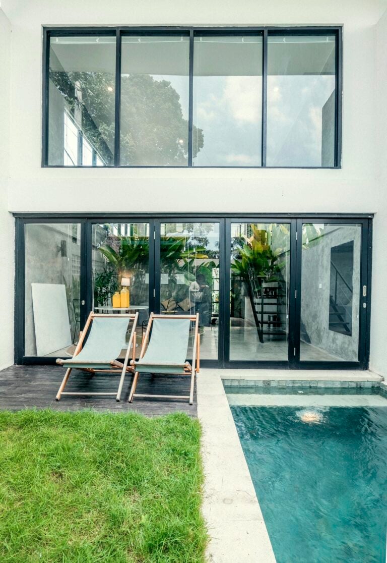 Modern house with pool and lounge chairs