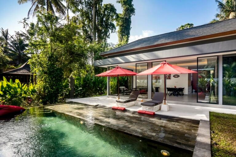 Luxury villa with pool and red umbrellas