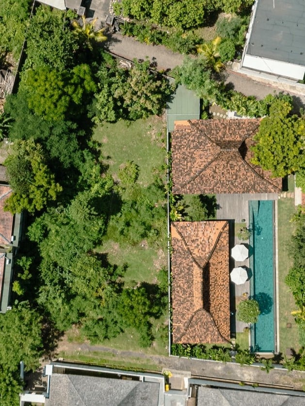 Aerial view of house with pool and garden.