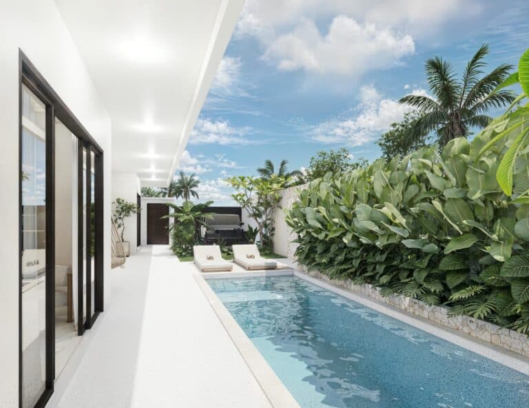 Tropical backyard with pool, lounge chairs, and palm trees.