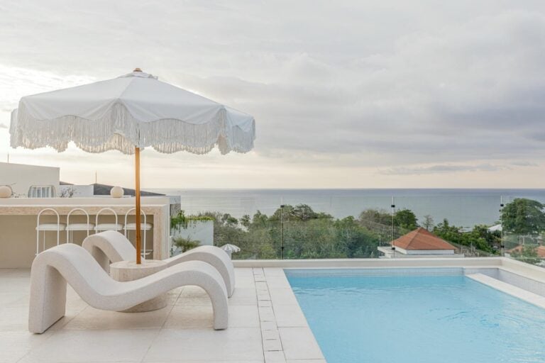 Luxury poolside view with ocean and umbrella
