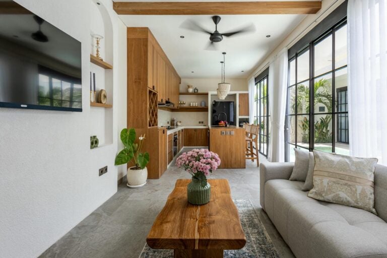 Modern kitchen with wooden elements and cozy living area.
