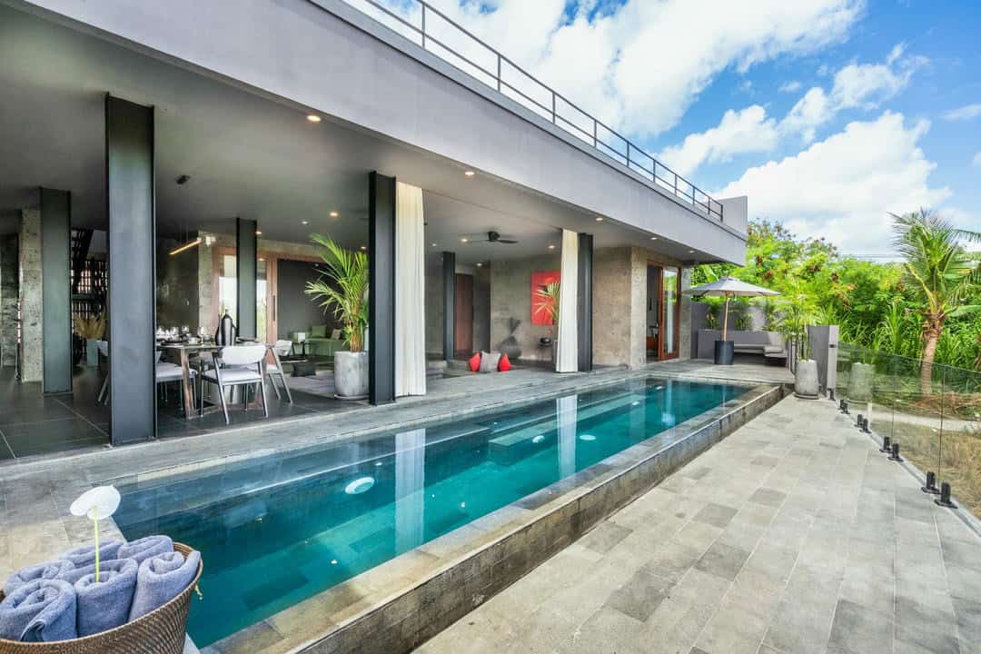 Modern villa with an outdoor pool and patio.
