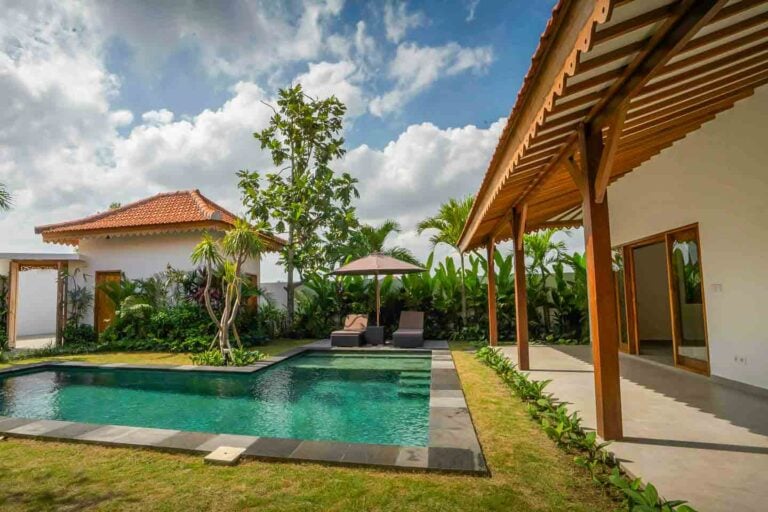 Tropical villa with pool and garden view.