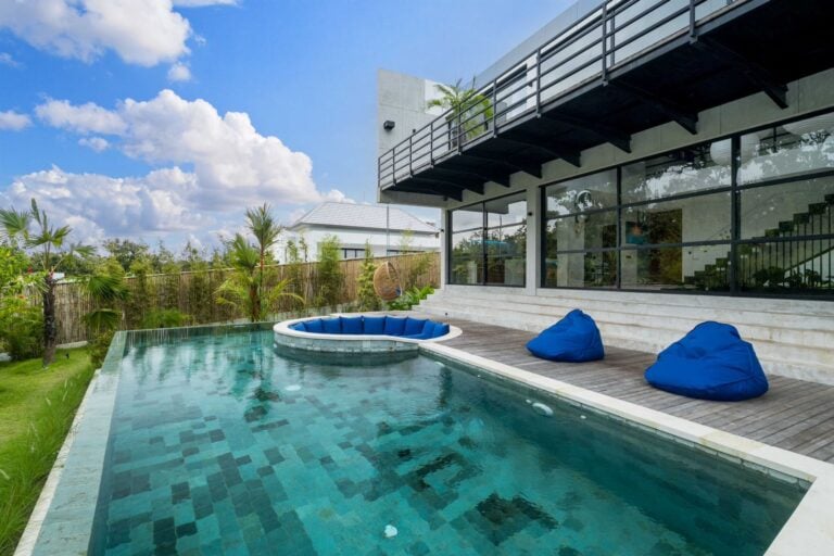 Modern house with pool and outdoor seating.