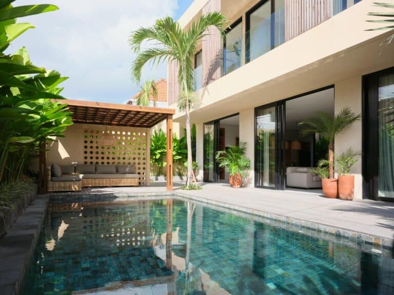 Luxury villa courtyard with pool and lounge area.